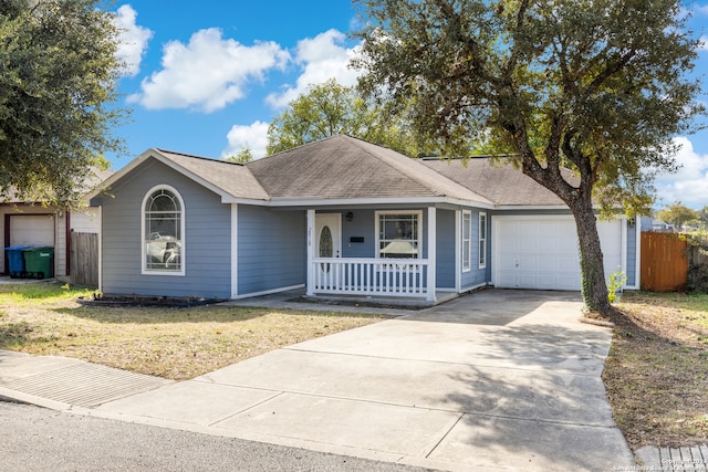 ranch-style house with a front yard, a porch, and a garage