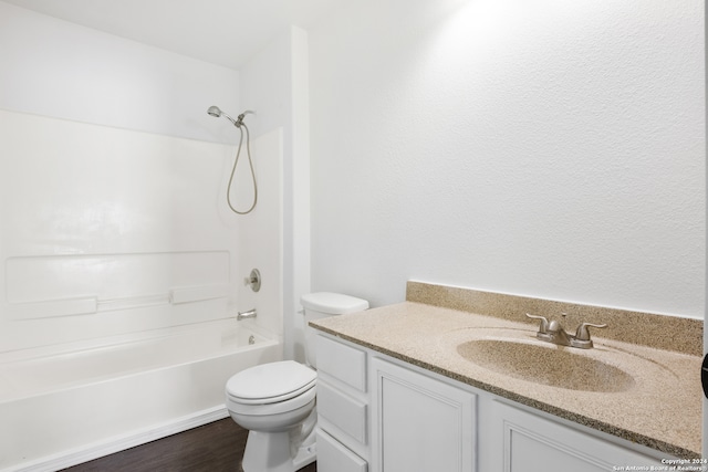 full bathroom featuring hardwood / wood-style flooring, vanity,  shower combination, and toilet