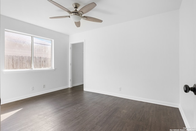 spare room featuring dark hardwood / wood-style flooring and ceiling fan