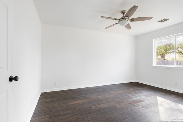 empty room with ceiling fan and dark wood-type flooring