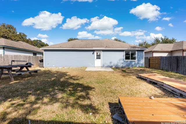 rear view of house with a lawn