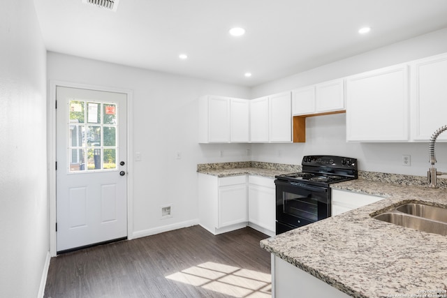 kitchen featuring white cabinets, electric range, dark wood-type flooring, and sink