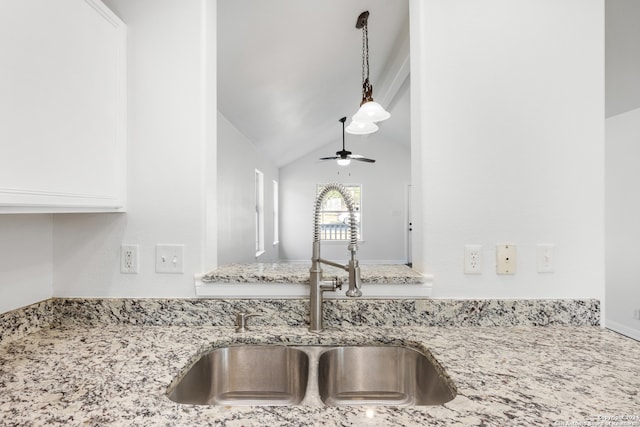 details with light stone countertops, pendant lighting, ceiling fan, and sink