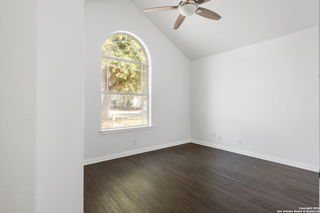 empty room featuring vaulted ceiling, ceiling fan, and dark hardwood / wood-style flooring