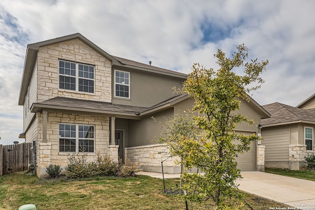 view of front of property featuring a front yard and a garage