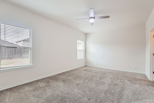 spare room featuring carpet flooring and ceiling fan