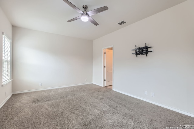 spare room with carpet and ceiling fan