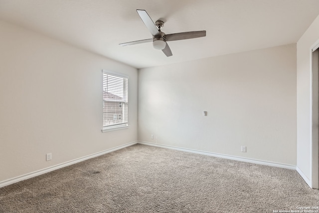 carpeted spare room featuring ceiling fan