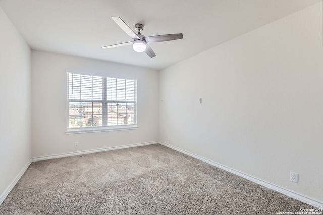 unfurnished room featuring ceiling fan and light carpet