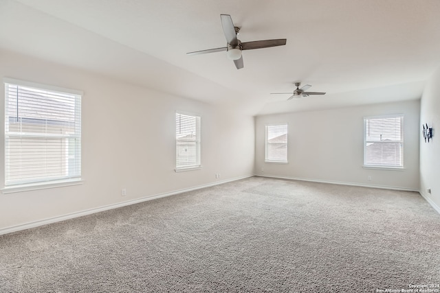 empty room featuring ceiling fan, a healthy amount of sunlight, and light carpet