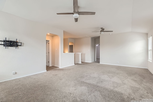 unfurnished living room with vaulted ceiling, carpet, and ceiling fan