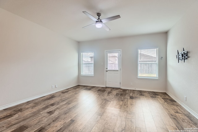 empty room with ceiling fan and hardwood / wood-style flooring