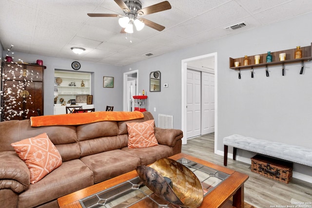 living room featuring light hardwood / wood-style floors and ceiling fan