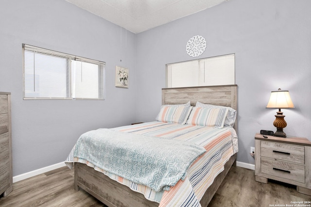 bedroom with hardwood / wood-style flooring