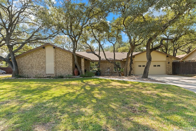 ranch-style house featuring a front yard and a garage