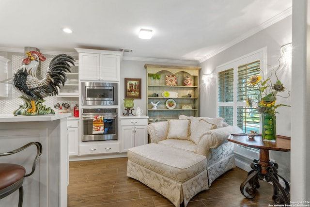 living area with dark hardwood / wood-style floors and crown molding