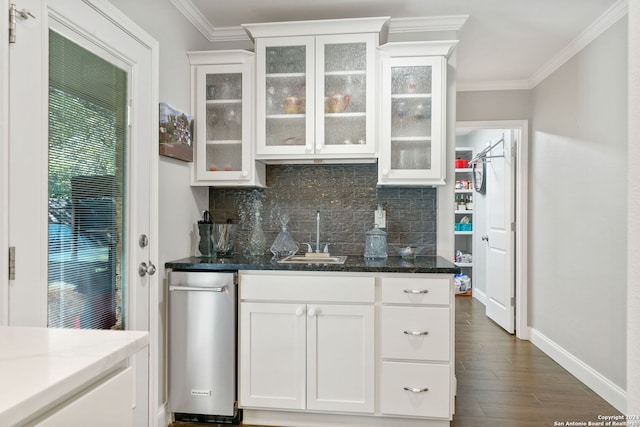 kitchen featuring sink, dark hardwood / wood-style floors, crown molding, dark stone counters, and white cabinets