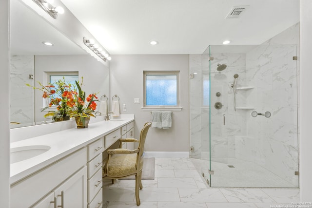 bathroom featuring vanity and an enclosed shower