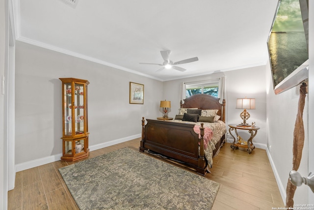 bedroom featuring ceiling fan, crown molding, and light wood-type flooring