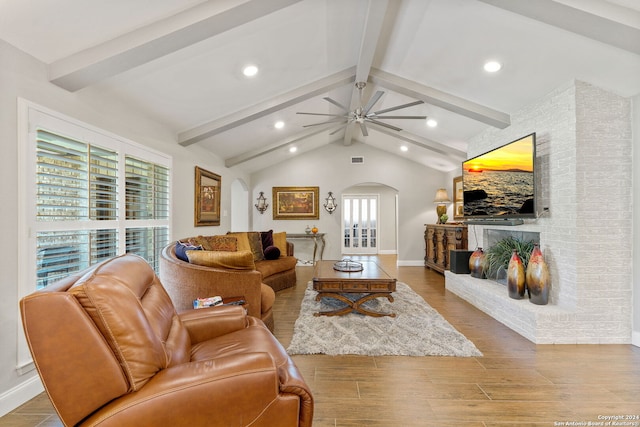 living room with vaulted ceiling with beams, ceiling fan, and hardwood / wood-style floors