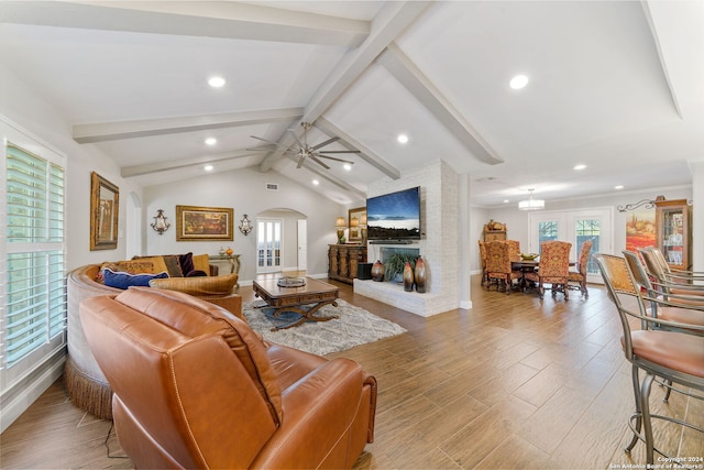 living room with vaulted ceiling with beams, ceiling fan, and hardwood / wood-style floors