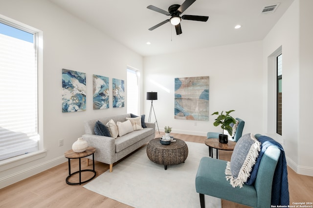 living room featuring ceiling fan and light hardwood / wood-style flooring