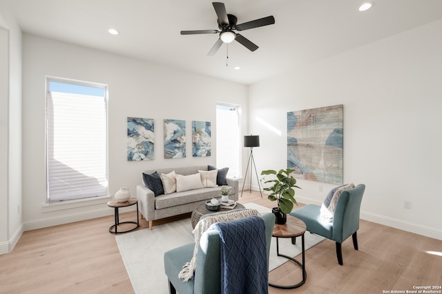 living room featuring ceiling fan and light hardwood / wood-style floors