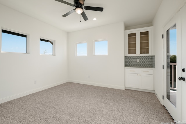 carpeted empty room featuring ceiling fan