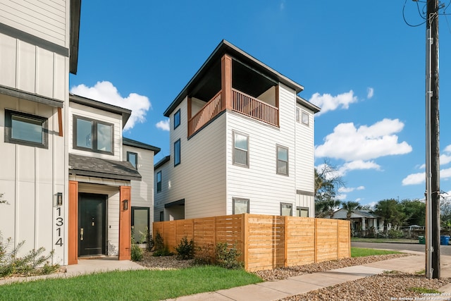 back of property featuring a balcony