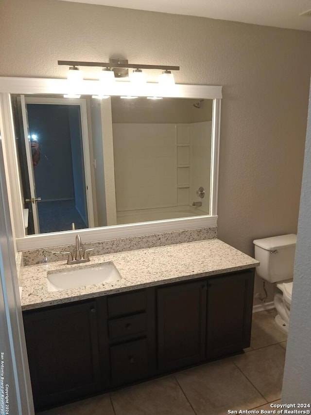 bathroom featuring vanity, toilet, and tile patterned floors