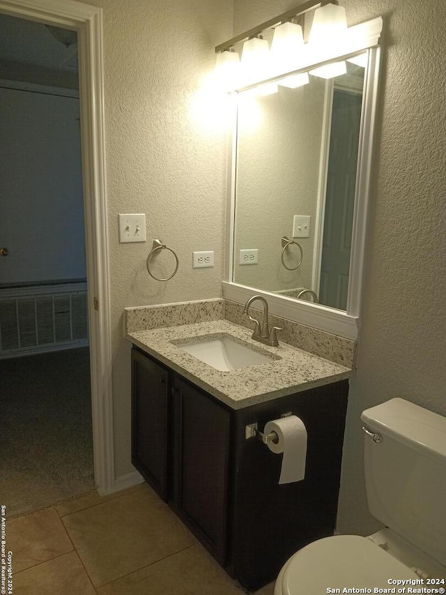 bathroom featuring tile patterned floors, vanity, and toilet