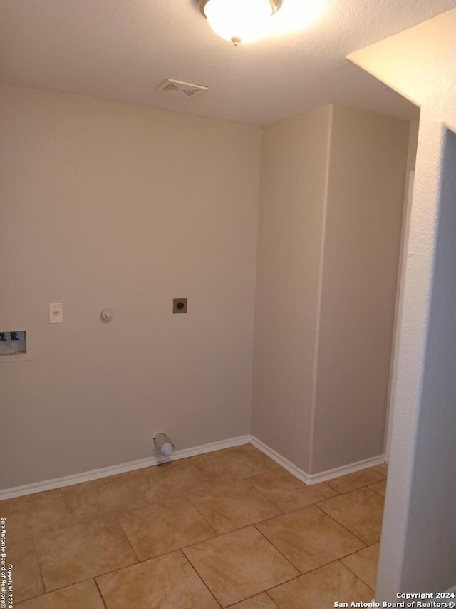 clothes washing area featuring light tile patterned flooring, hookup for a gas dryer, hookup for an electric dryer, and washer hookup