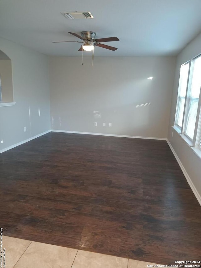 unfurnished room featuring ceiling fan and dark hardwood / wood-style floors