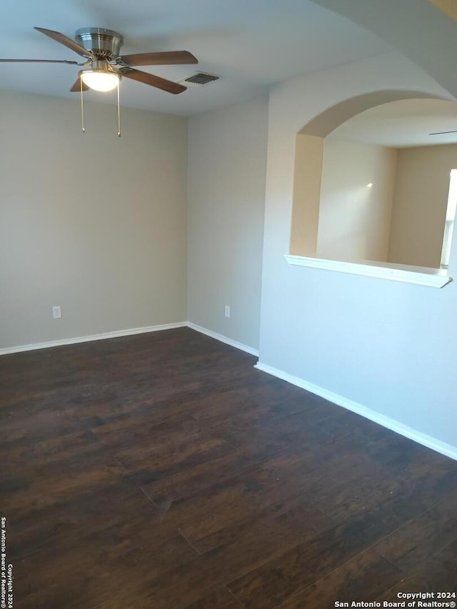 spare room with ceiling fan and dark wood-type flooring