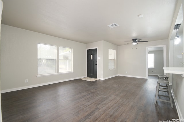 unfurnished living room with ceiling fan and dark hardwood / wood-style flooring