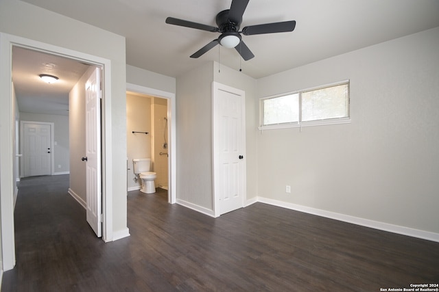 unfurnished bedroom featuring dark hardwood / wood-style floors, ensuite bath, a closet, and ceiling fan