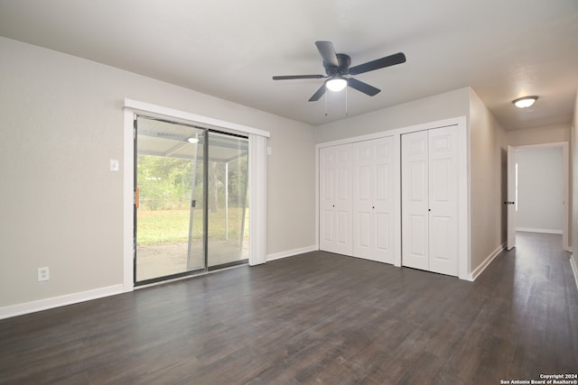 unfurnished bedroom with a closet, ceiling fan, access to exterior, and dark hardwood / wood-style flooring