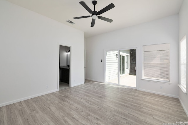 empty room with ceiling fan and light hardwood / wood-style floors