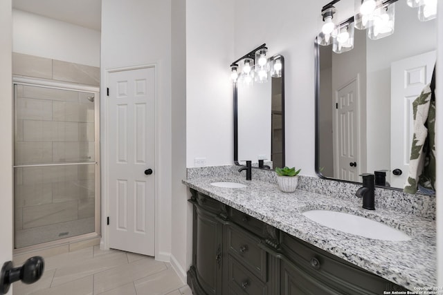 bathroom featuring vanity, tile patterned floors, and a shower with shower door