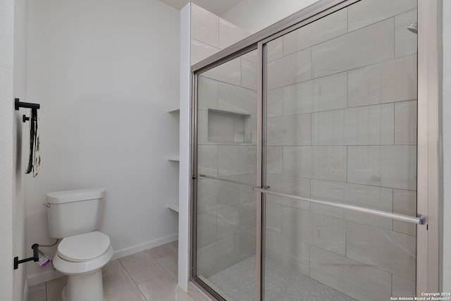 bathroom featuring an enclosed shower and toilet