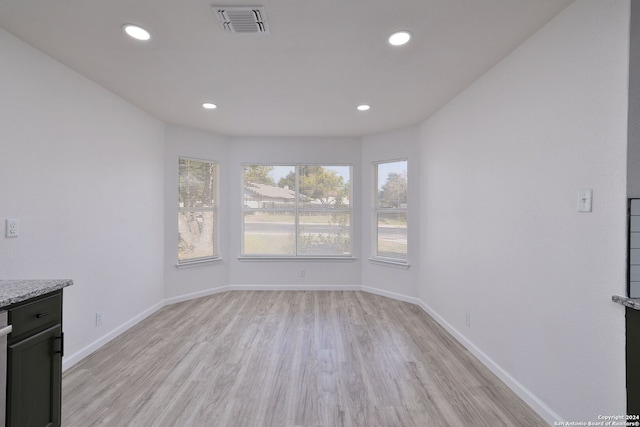 unfurnished dining area with light hardwood / wood-style floors