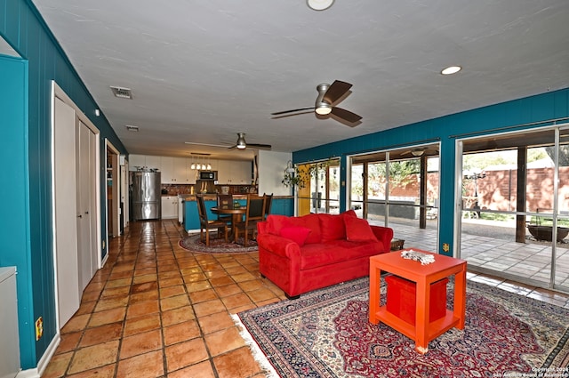 tiled living room featuring ceiling fan