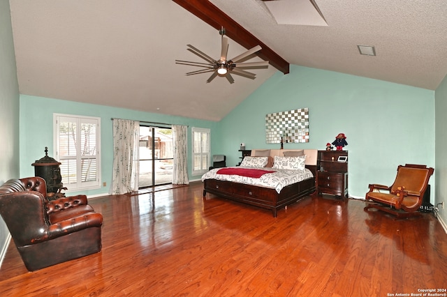 bedroom with vaulted ceiling with beams, ceiling fan, wood-type flooring, and a textured ceiling