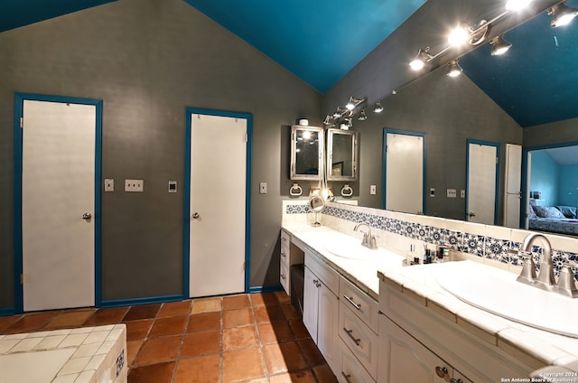 bathroom featuring backsplash, vanity, and high vaulted ceiling