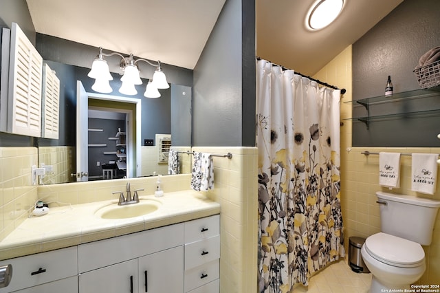 bathroom with vanity, tile walls, toilet, curtained shower, and lofted ceiling