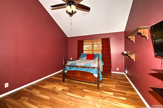 bedroom with hardwood / wood-style flooring, vaulted ceiling, and ceiling fan