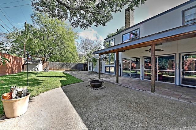 view of yard featuring ceiling fan and a patio area