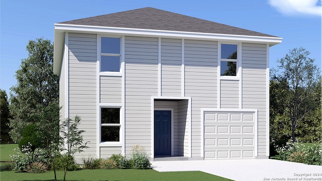 view of front of house featuring a front yard and a garage