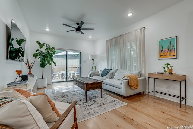 living room featuring ceiling fan and light wood-type flooring