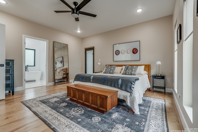 bedroom featuring connected bathroom, ceiling fan, and light wood-type flooring